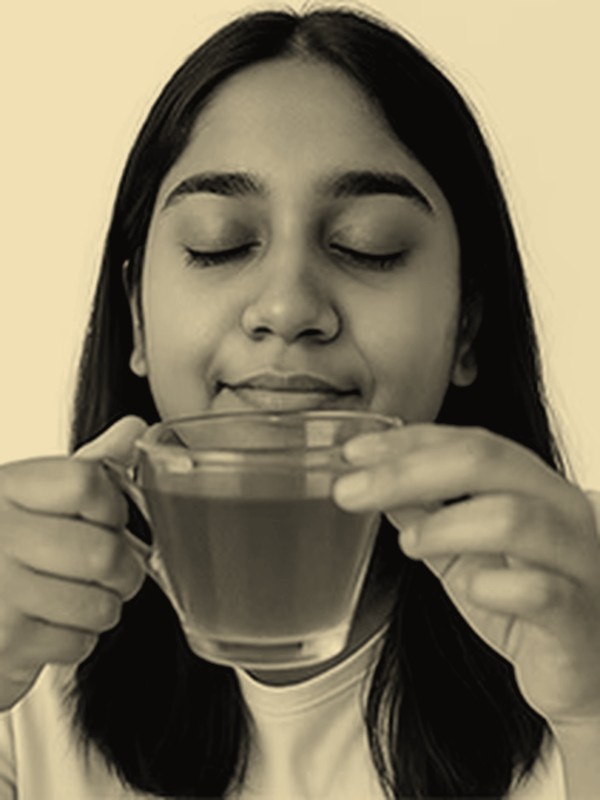 Woman sipping tea, hormonal balance concern
